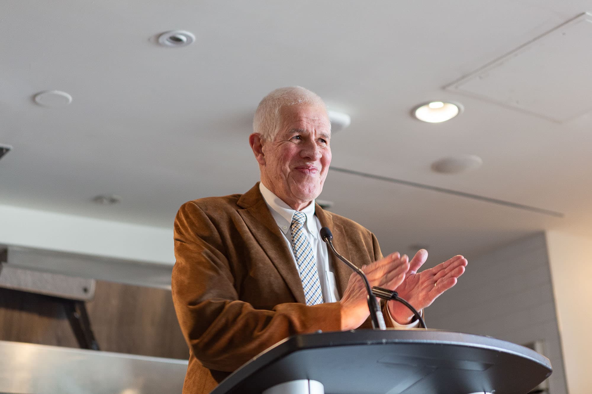 Photo of Peter Oliver standing at a podium