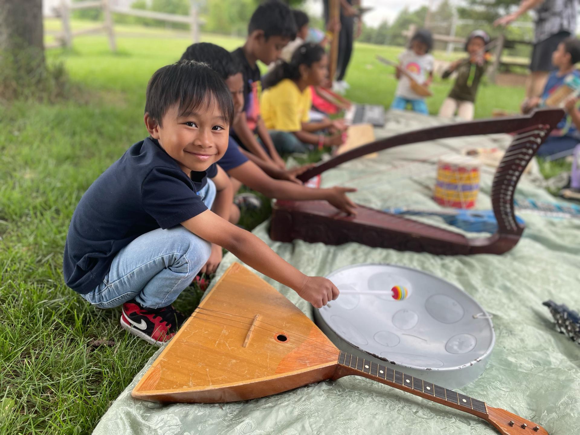 Photo of LiftED program participants playing with musical instruments outdoors