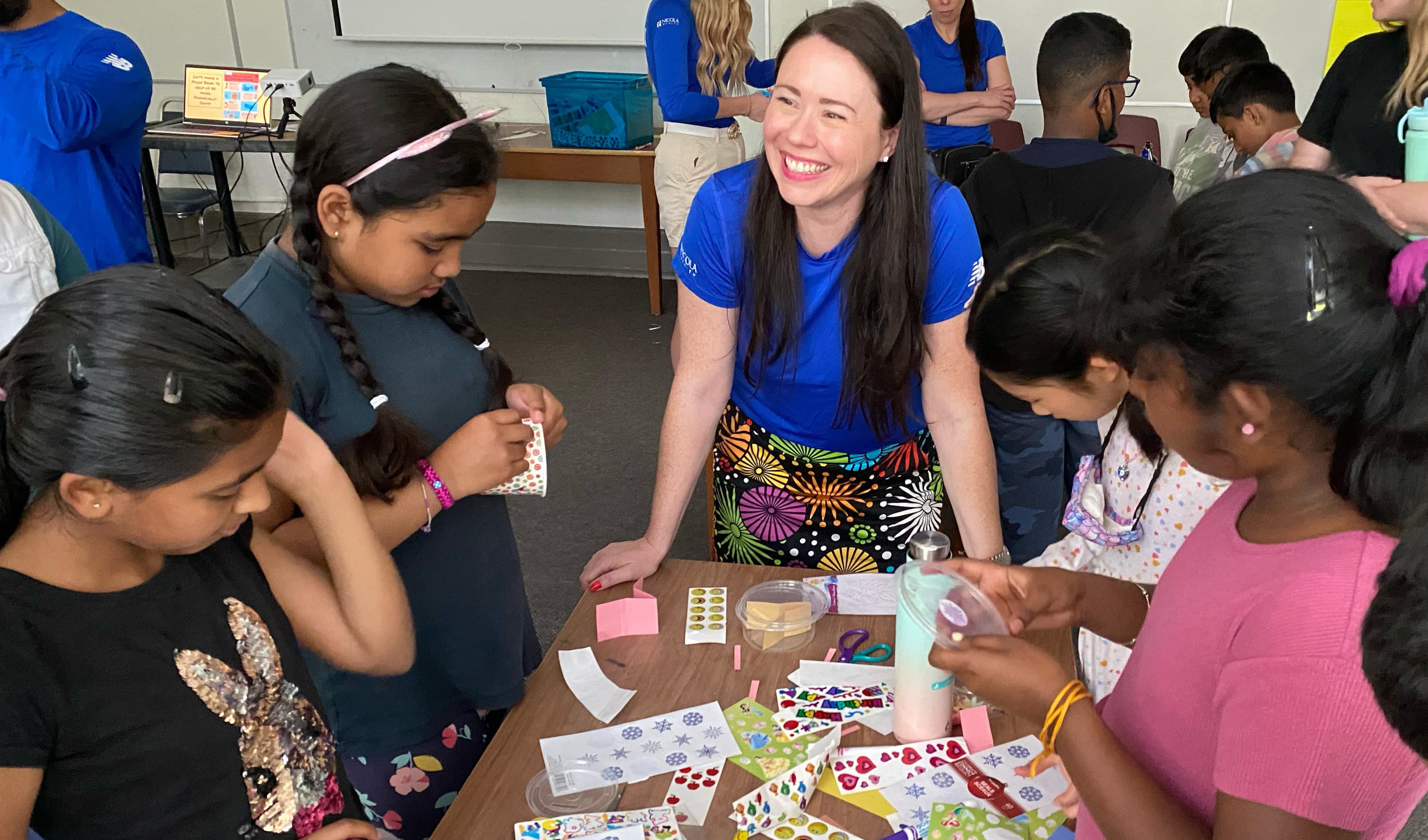 Photo of a corporate volunteer from Nicola Wealth interacting with LiftED program participants